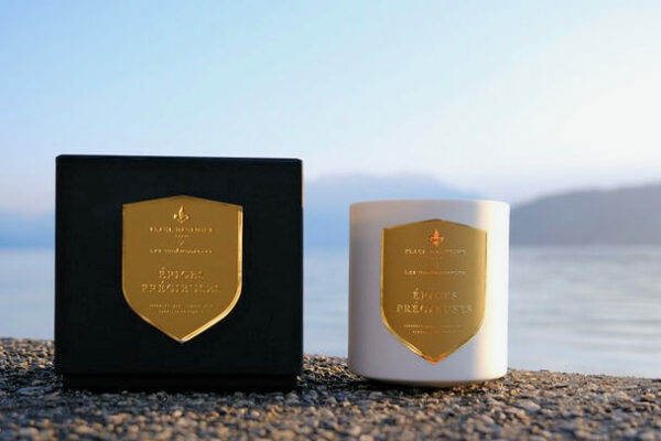 Épices Précieuses luxury box and scented candle set against a natural landscape, Lake Annecy.